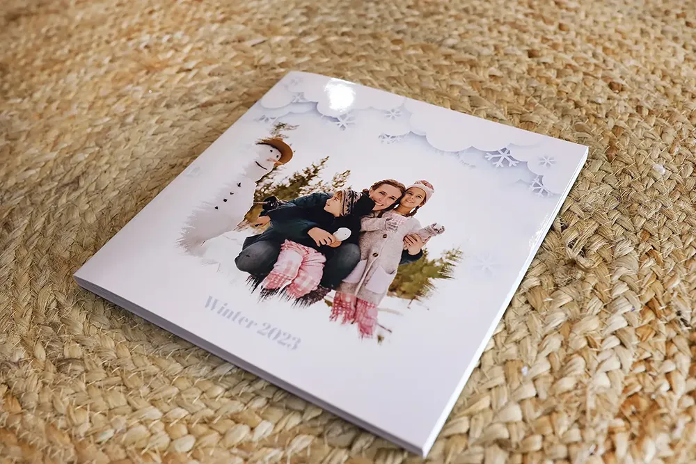 An image of our product's softcover, a paperback photo album with the text 'Winter' on its cover.
