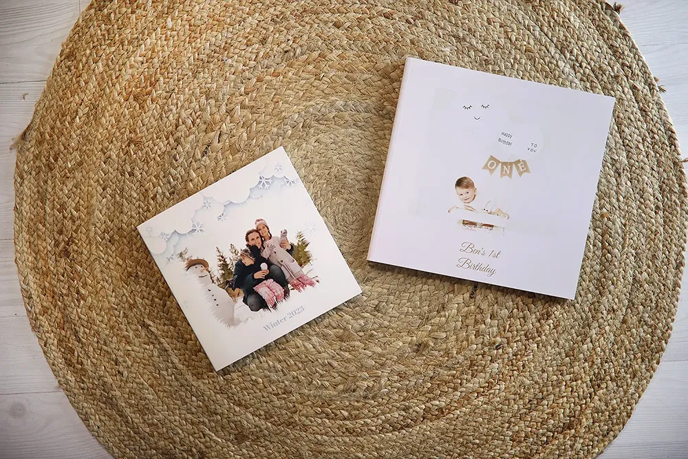 An image contains two photo albums with different and personalized text on the covers.